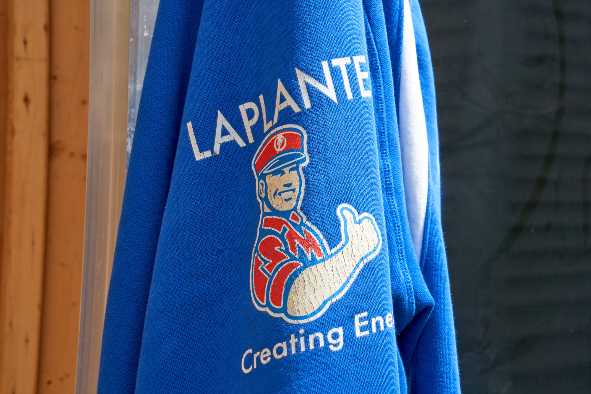 A LaPlante sweatshirt with the logo hangs by the hood
