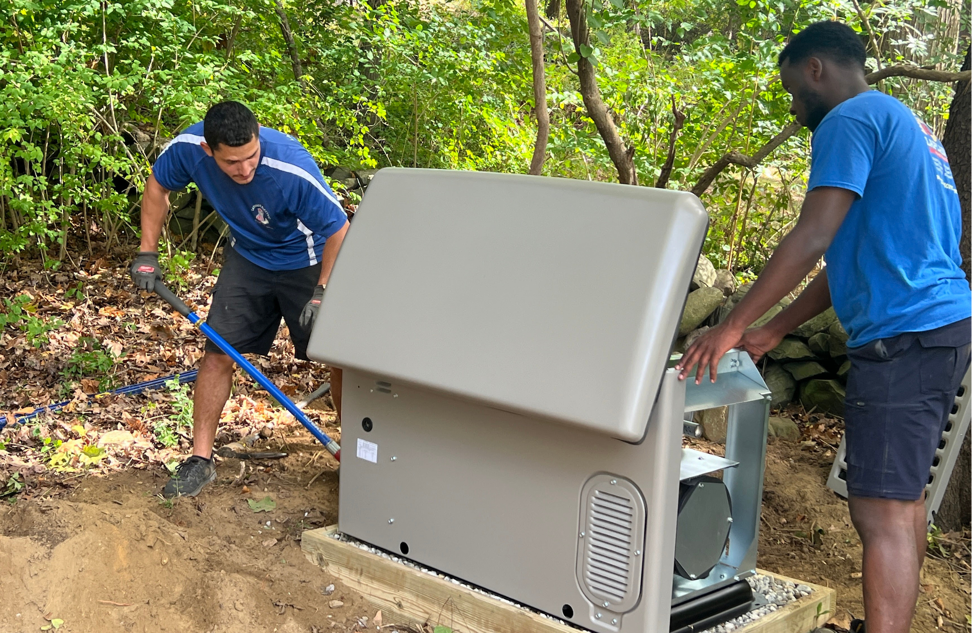 Two LaPlante technicians inspect a standby generator